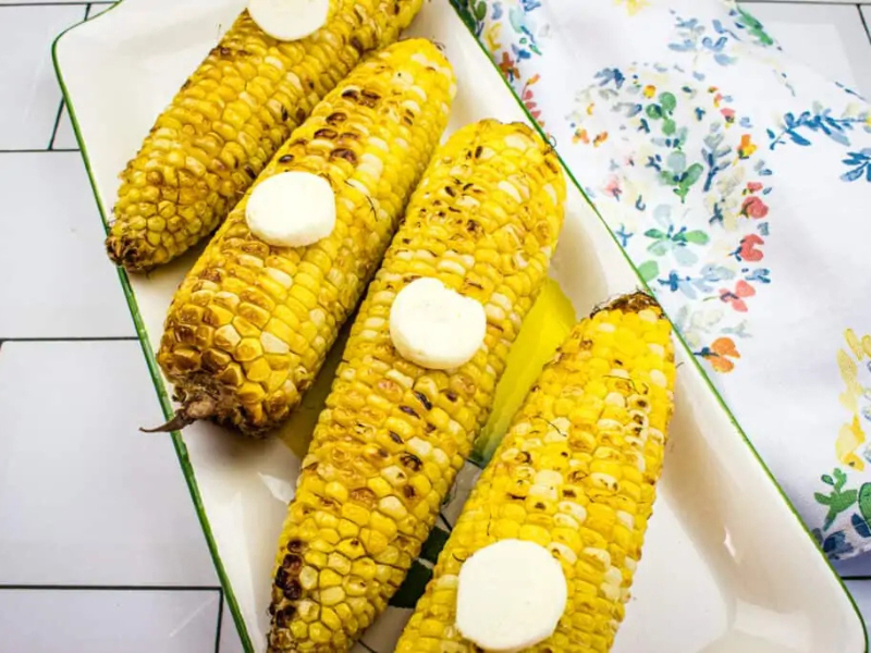 Air Fryer Corn on the Cob with slices of butter on top.