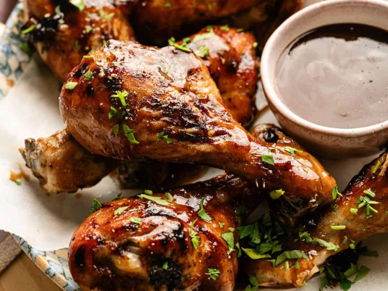 Juicy, crispy glazed chicken drumsticks with herbs and dipping sauce.