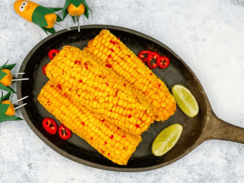 Three chili and lime corns on a skillet.