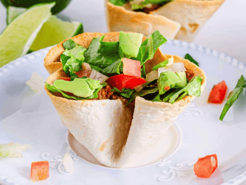 Mexican taco salad cups on a plate.