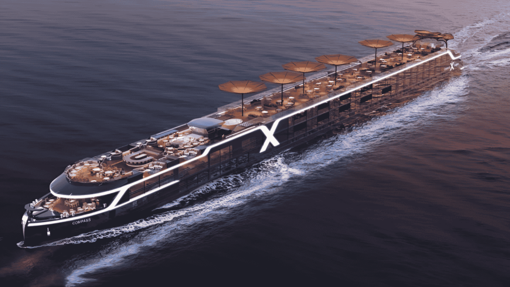A modern river cruise ship with multiple decks, outdoor seating areas, and large sun umbrellas sails on calm water at sunset.
