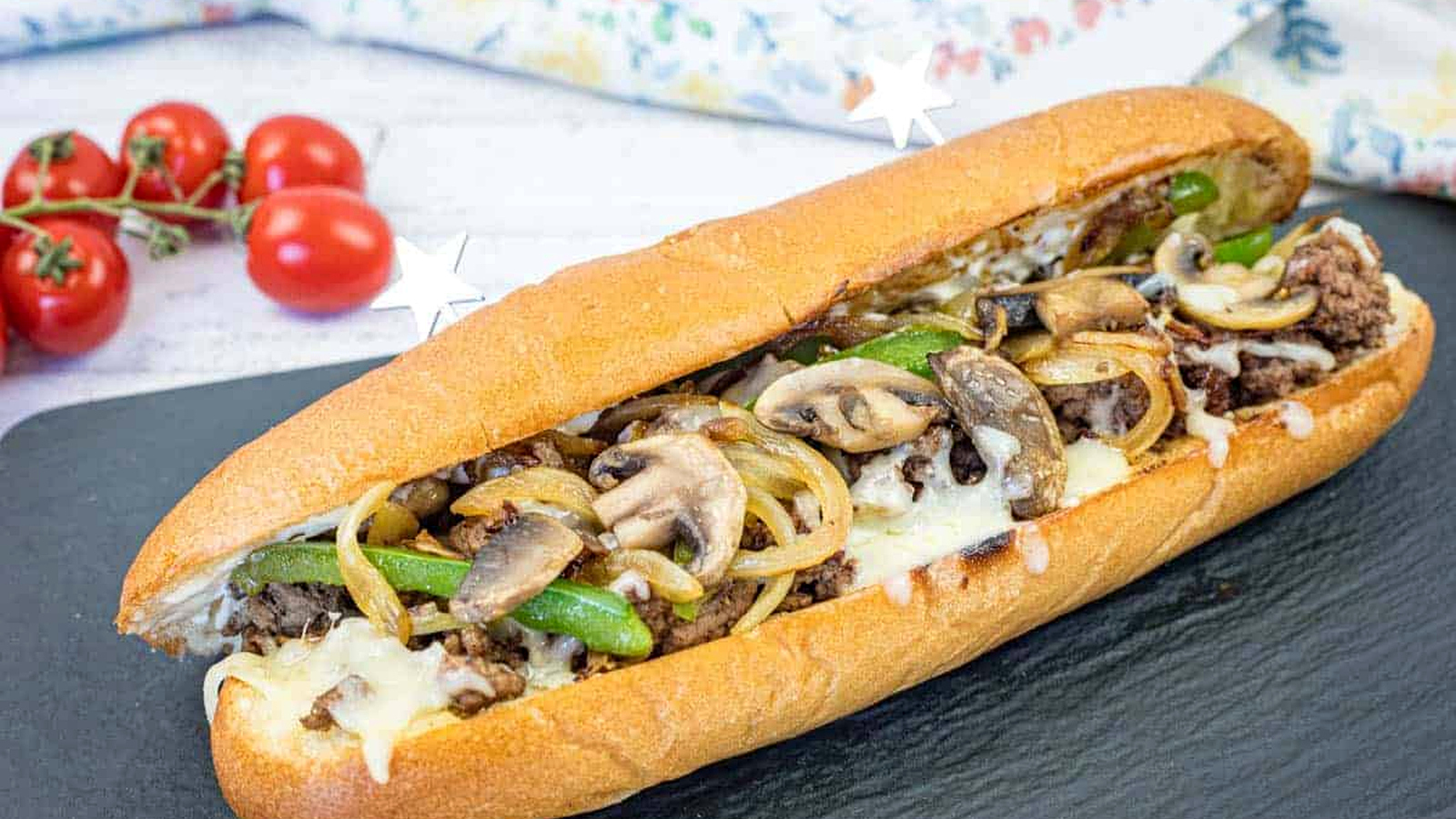 Ground Beef Philly Cheesesteak on a black slate plate.