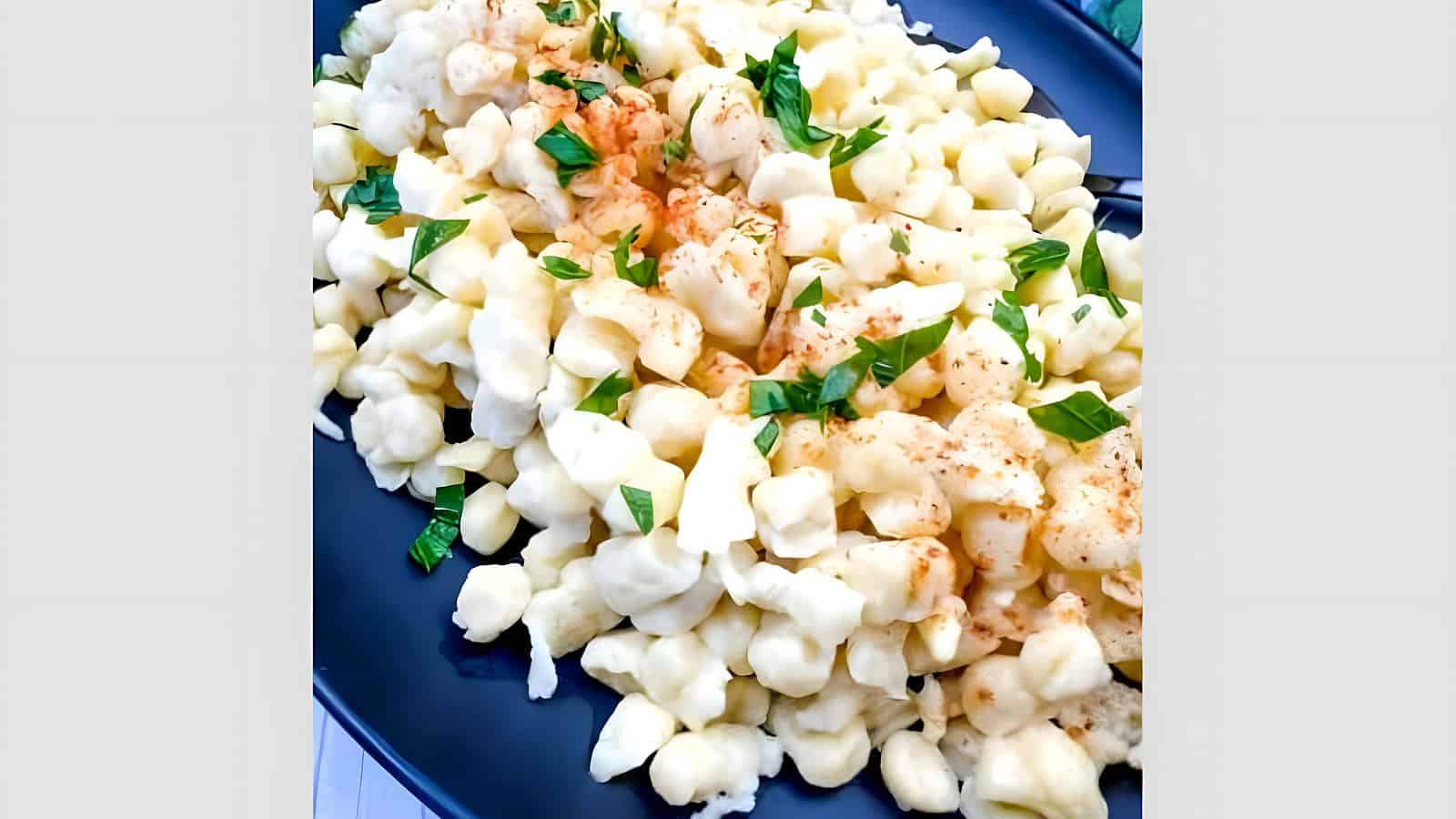 A plate of Authentic German Spaetzle garnished with parsley.