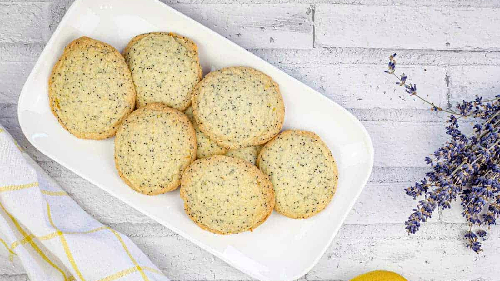 A top-down shot of Lemon Poppy Seed Cookies on a white plate.