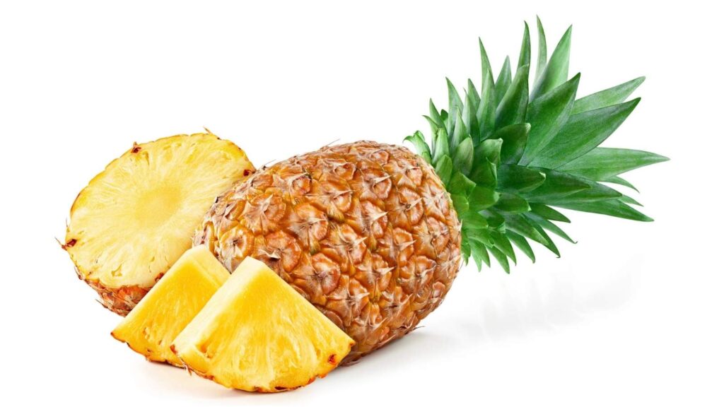 A whole pineapple with green leaves, one round slice, and two triangular wedges of pineapple, all on a white background.