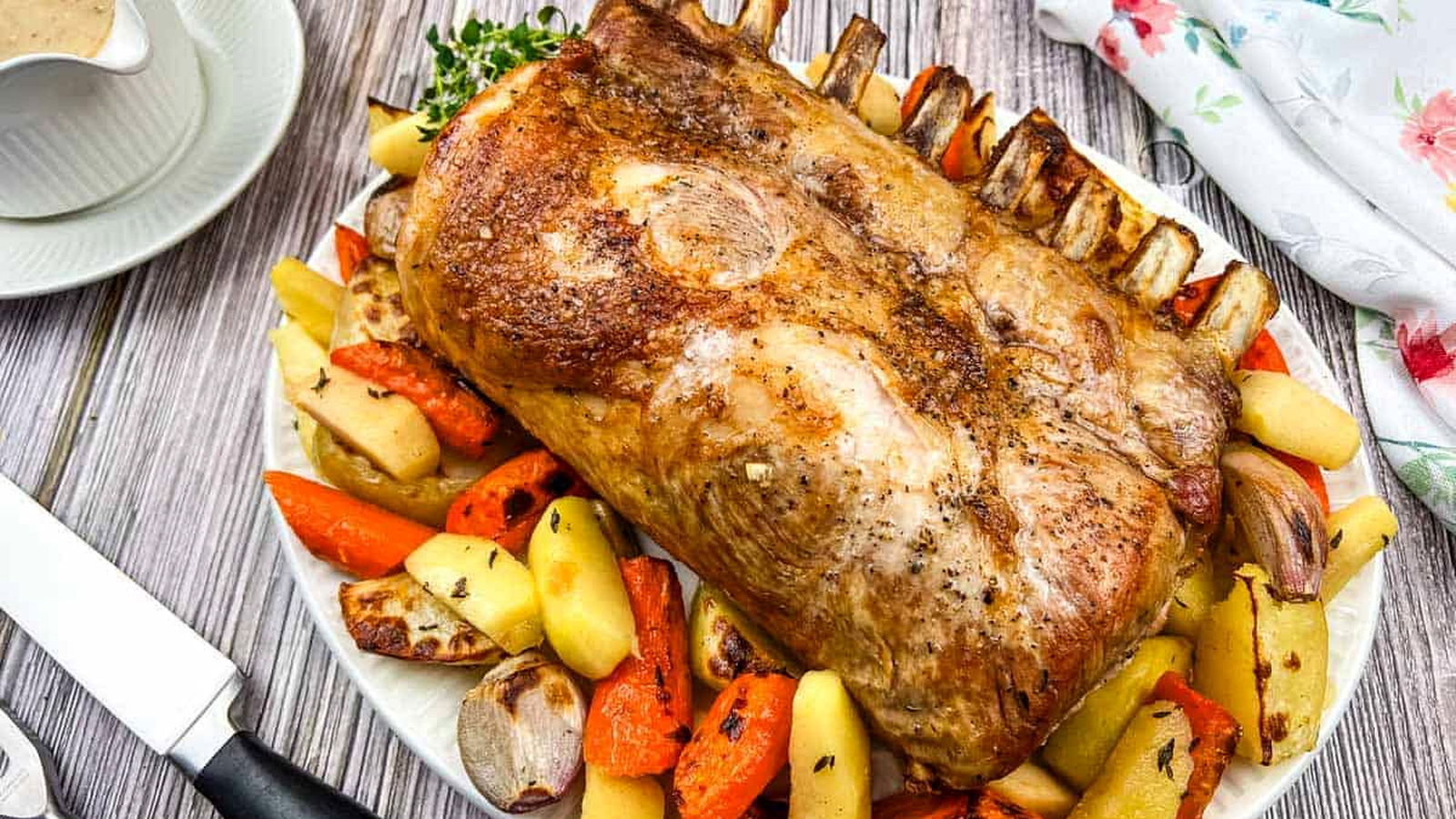 A plate of Pork Roast with Apples on a table.