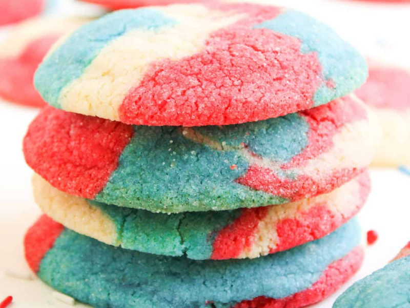 A stack of round cookies with a marbled pattern of red, blue, and white colors.