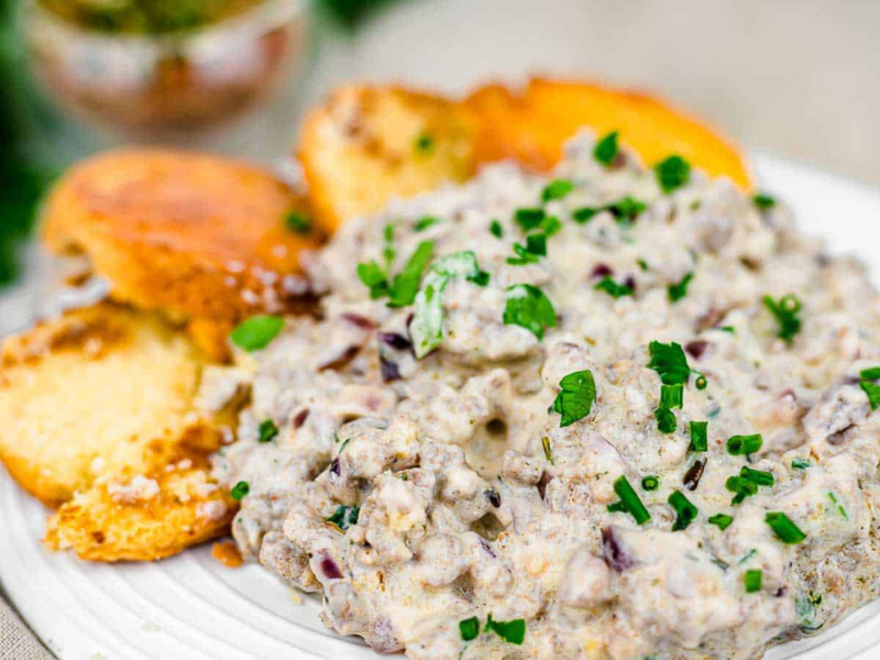 Keto gravy on a plate with biscuits.