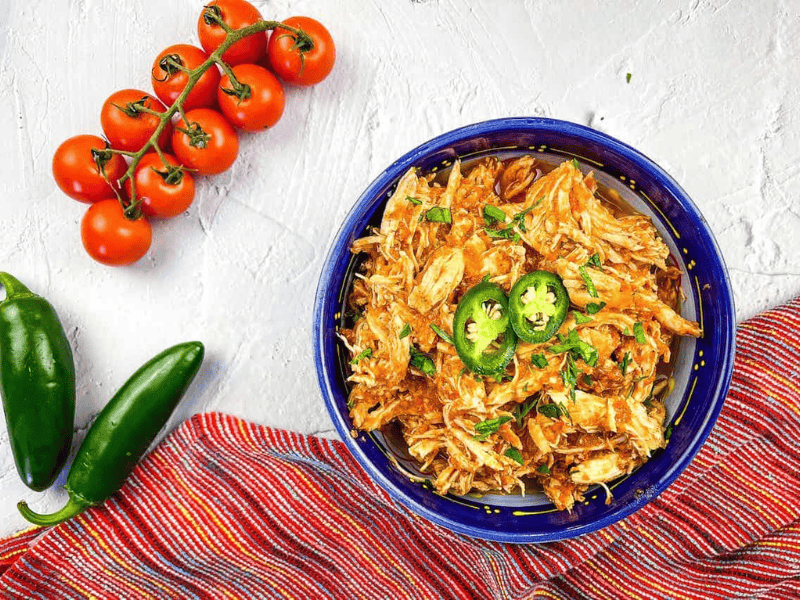 Chicken tinga in a blue bowl.