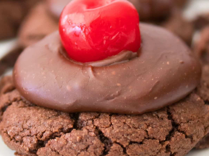 Enjoy our chocolate cherry cookies, each topped with a swirl of rich chocolate frosting and a vibrant red cherry.