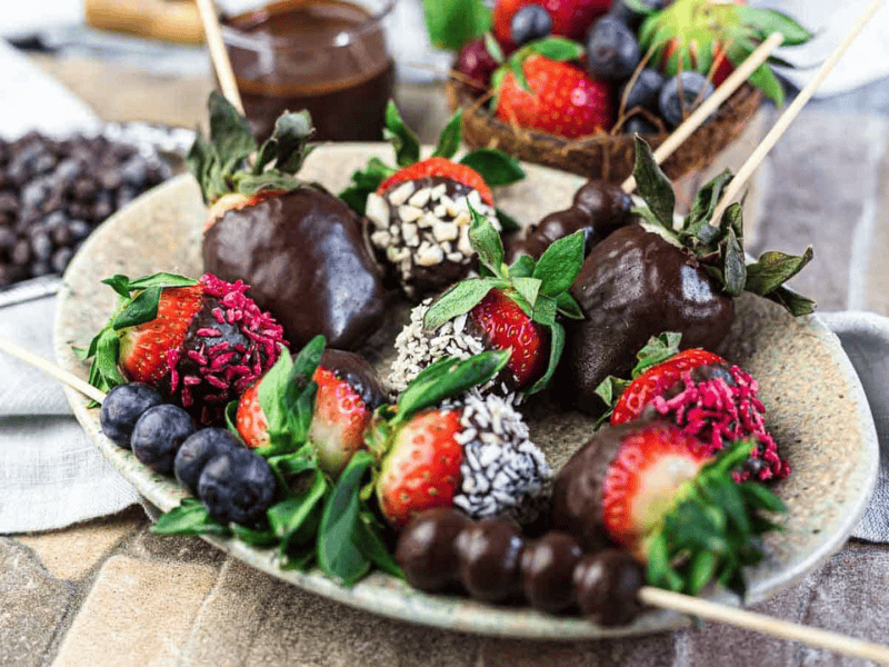 Chocolate Covered Strawberries and berries on a plate.