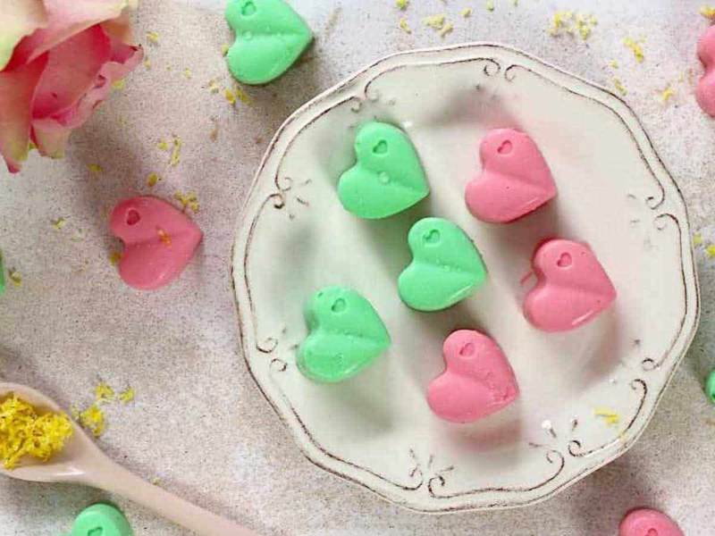 Cream Cheese Fat Bombs in green and pick on a plate and white board.