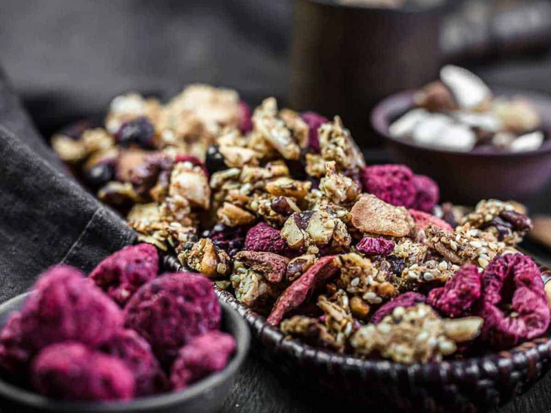 Muesli Granola with dry berries inside brown basket.