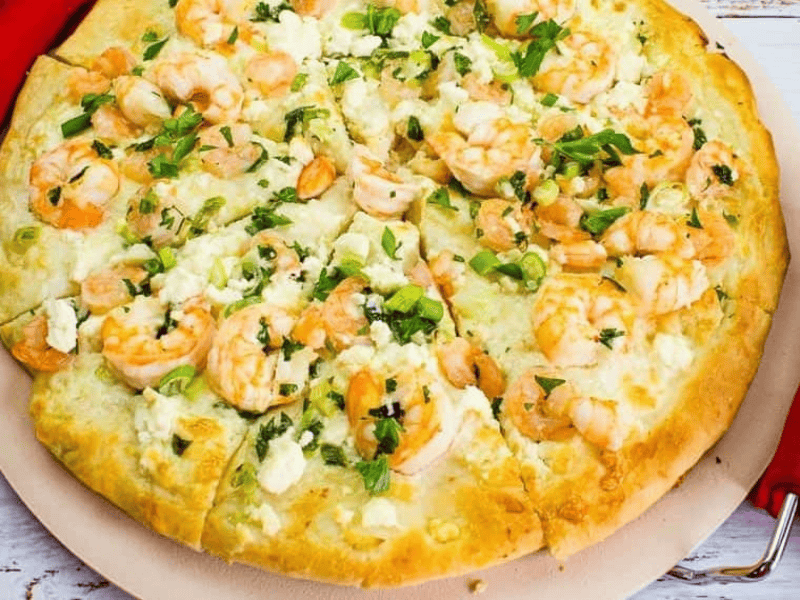 A pizza with shrimp and cheese on top.