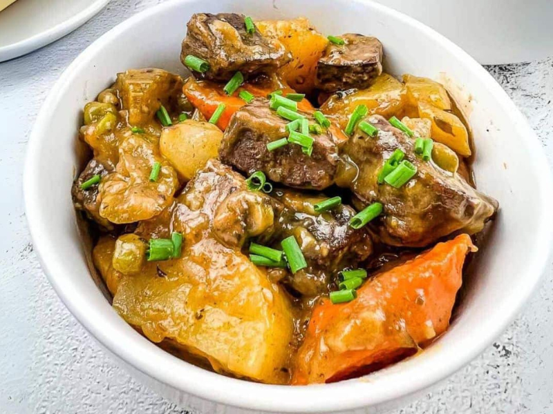 A white bowl filled with smoked beef stew.