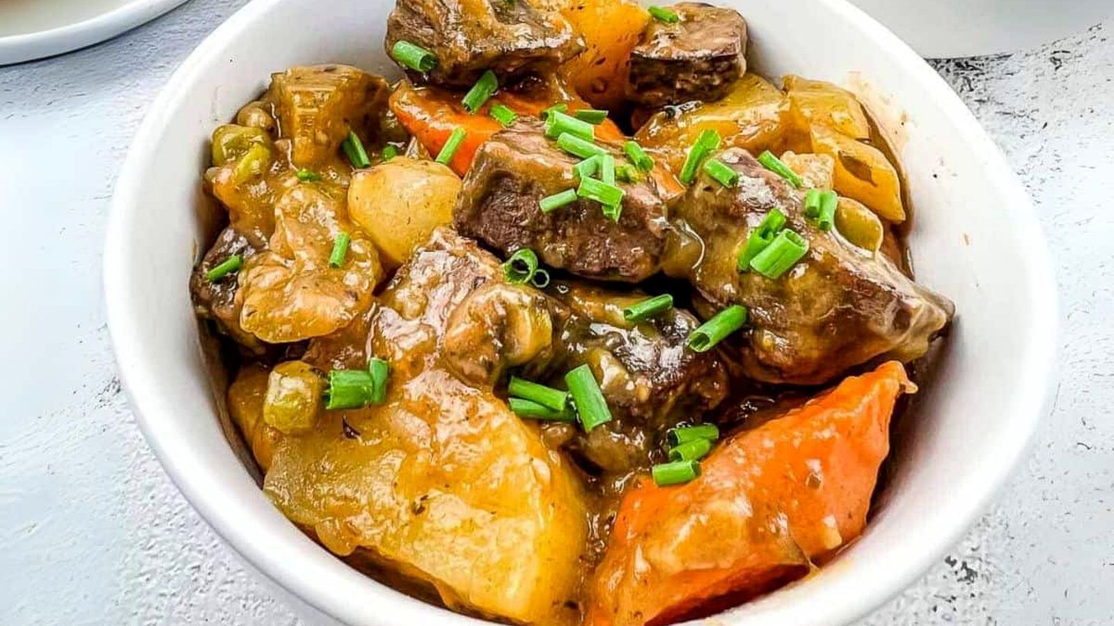 A white bowl filled with smoked beef stew.