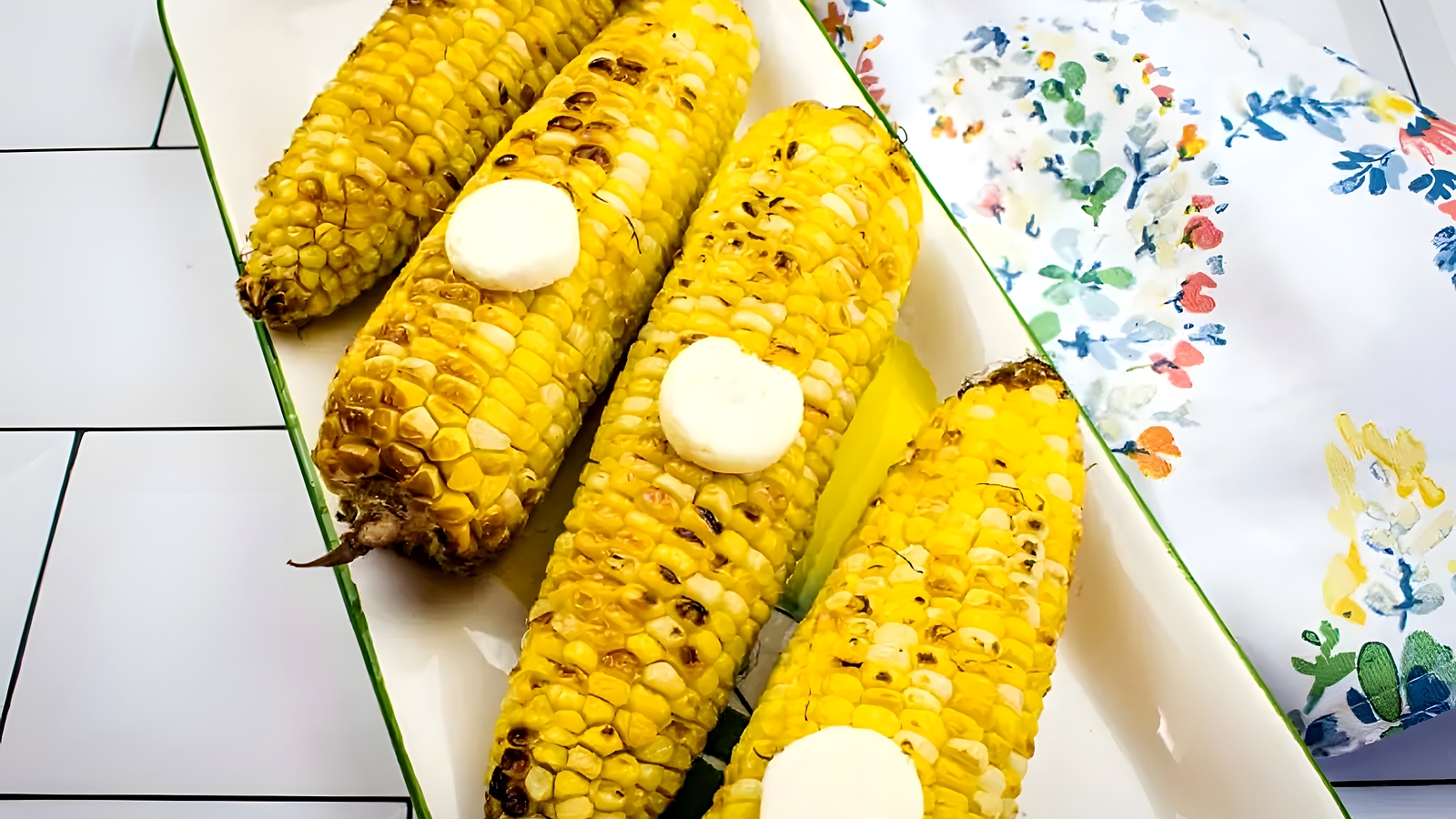 Air Fryer Corn on the Cob with slices of butter on top.