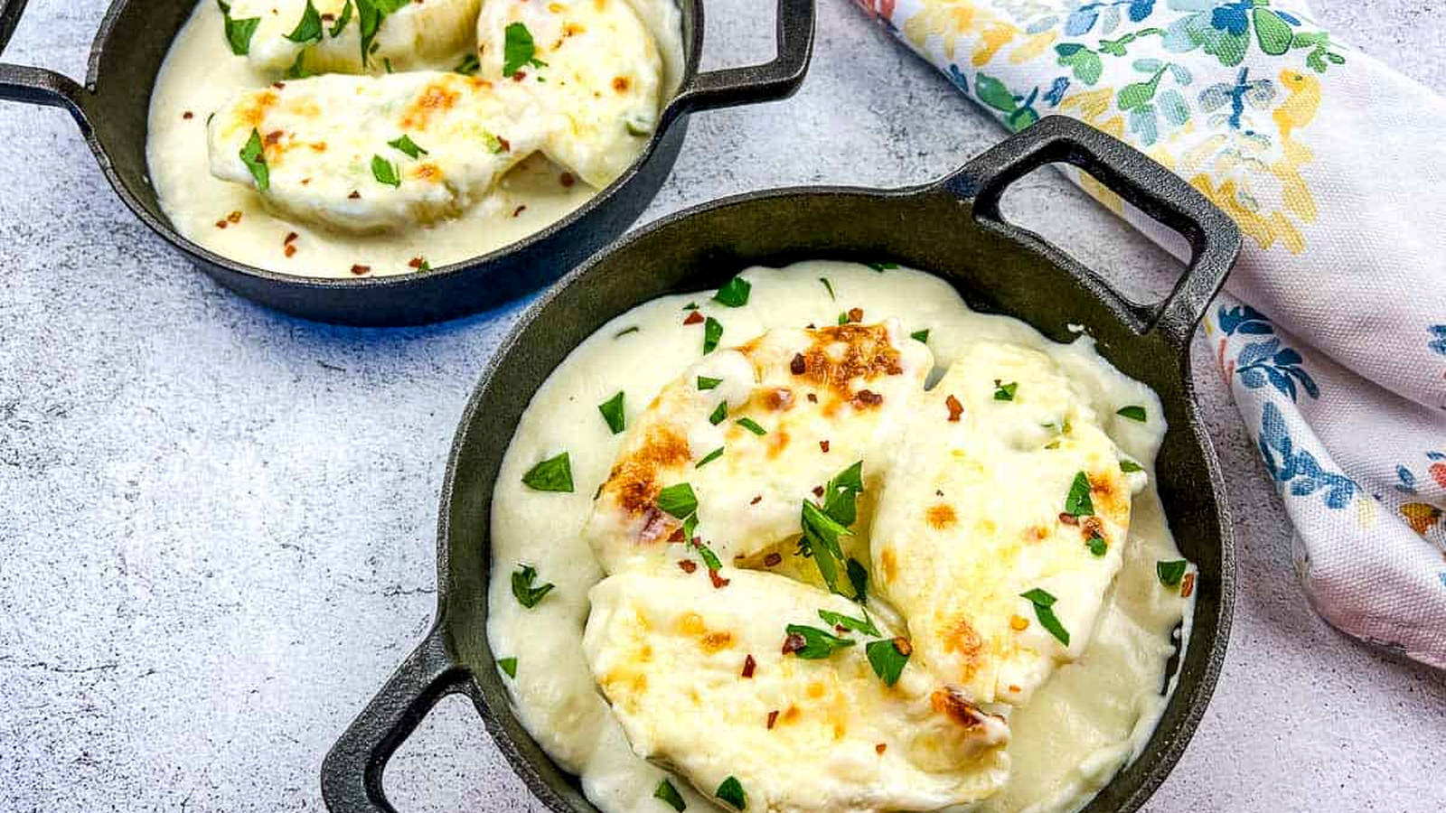 Giant Cheese Stuffed Pasta Shells in two black serving dishes.