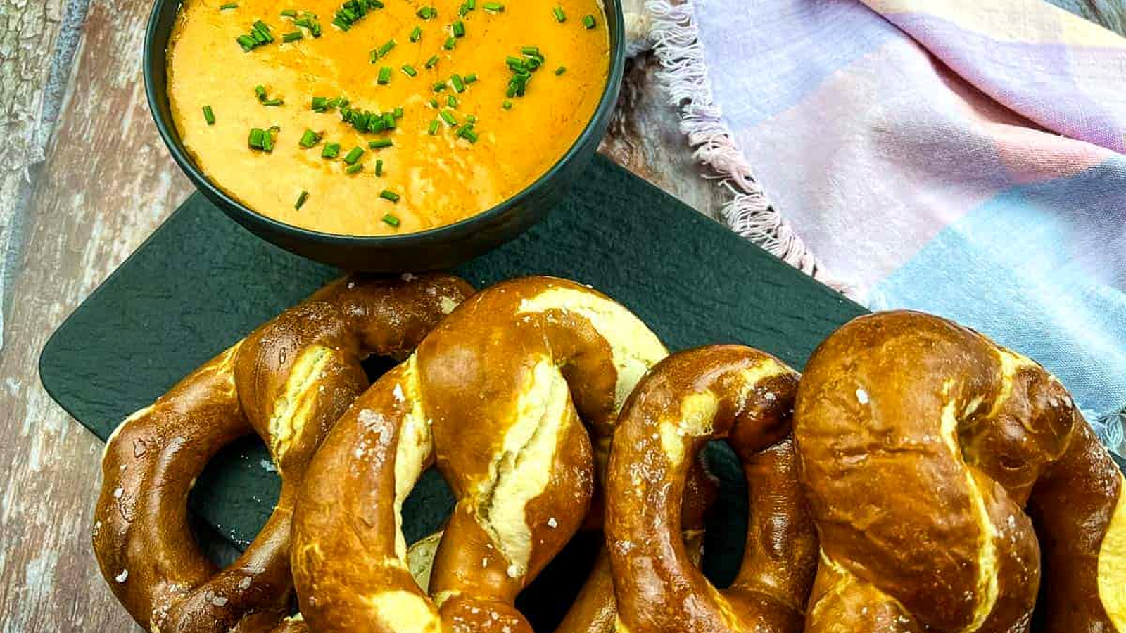 Guinness Cheese Dip on a platter with soft pretzels.