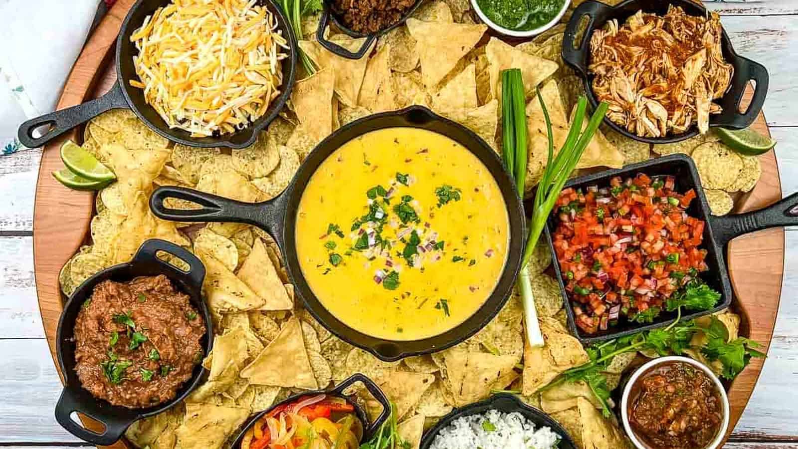 A platter of nachos with different toppings.