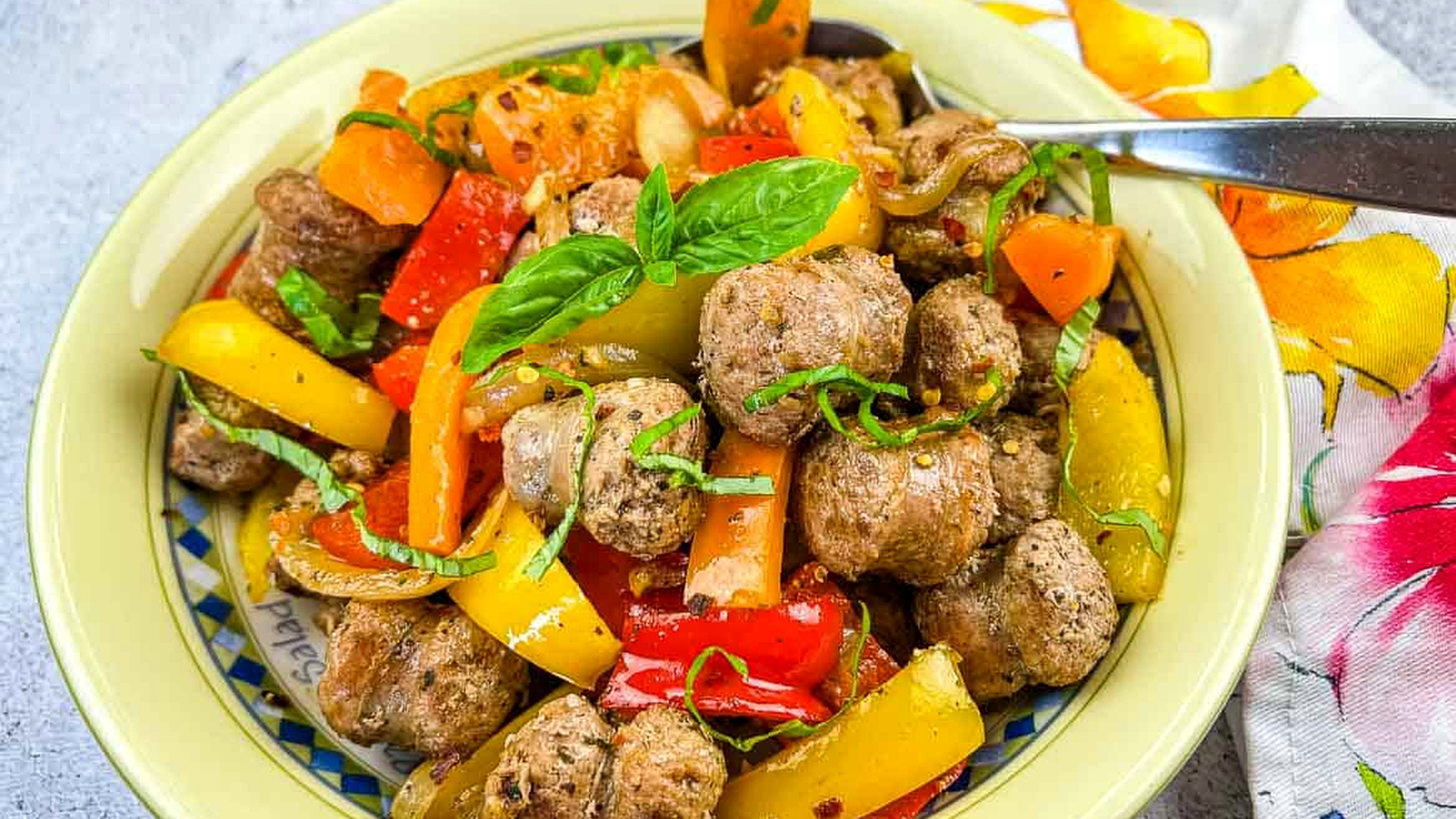 A bowl of sausage and peppers.