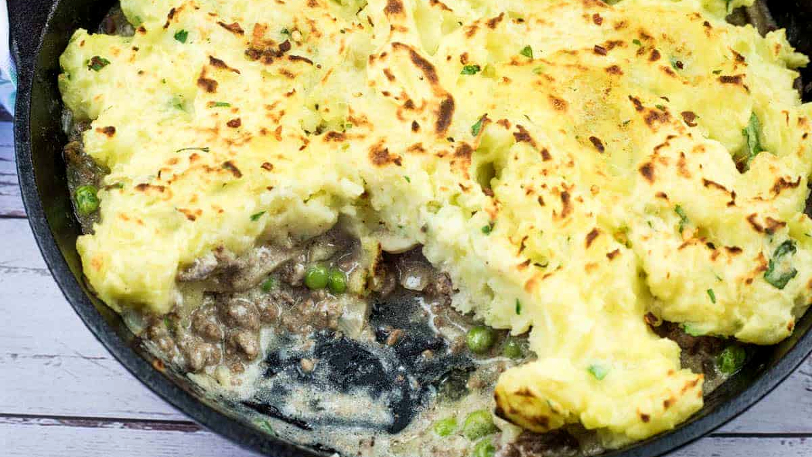 A Skillet Stroganoff Pie with a small missing portion.