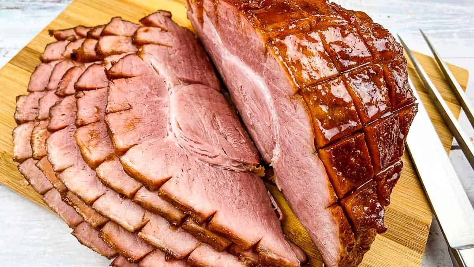 Smoked sliced ham on a cutting board.