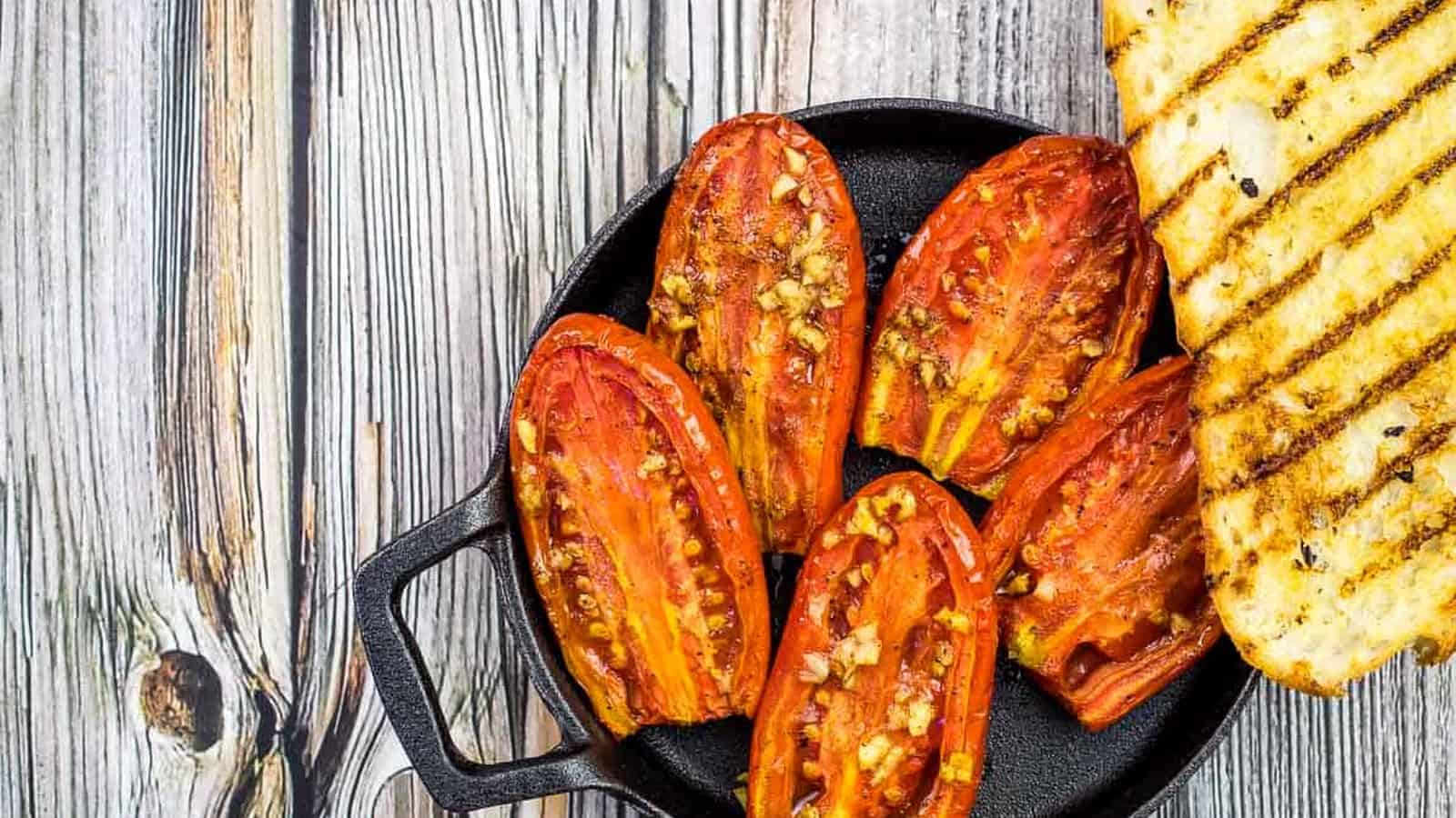 Smoked tomatoes in a dish with grilled bread.