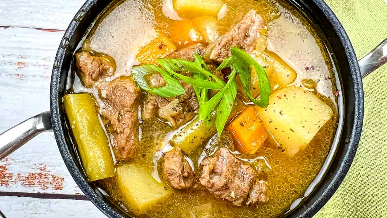 Steak & Potato Soup in a black bowl.