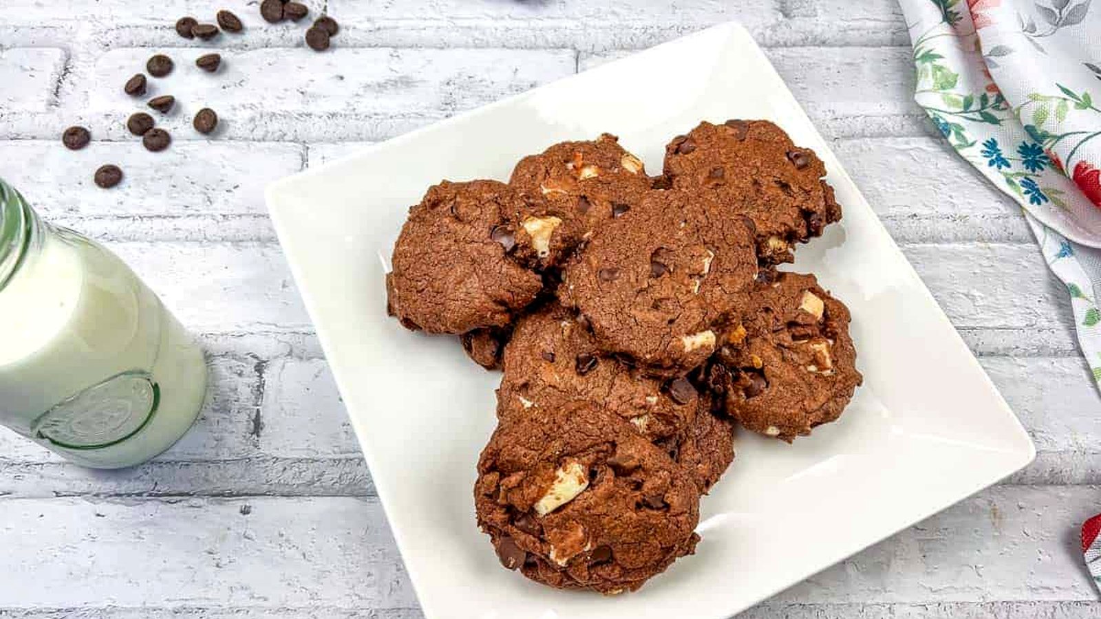 Chocolate overload cookies on a white plate.