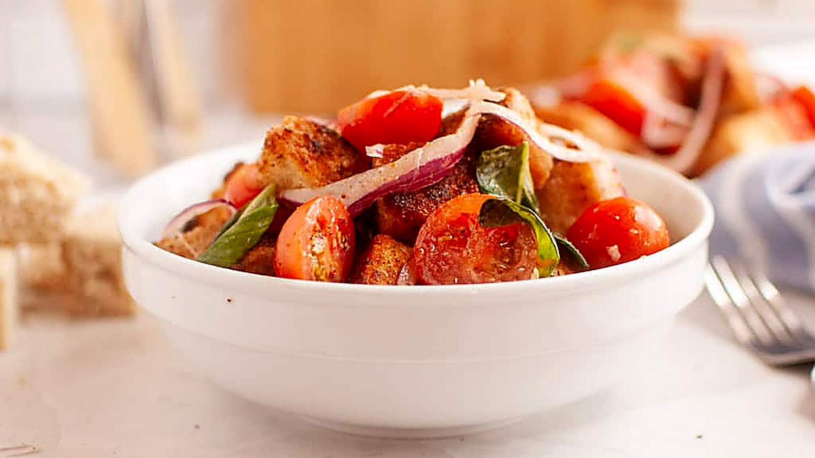 A white bowl filled with Old-Fashioned Panzanella Salad.