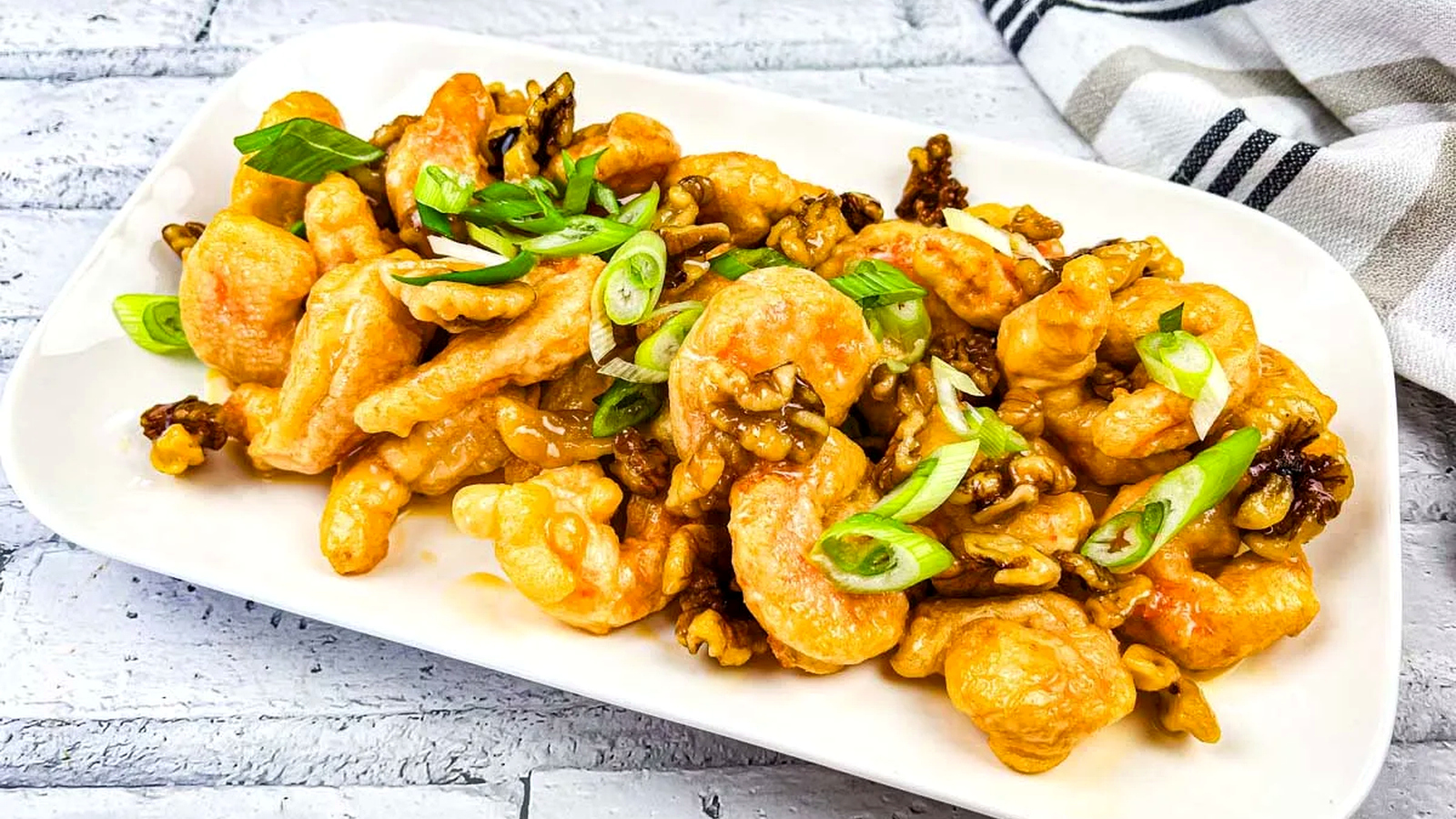 A plate of Copycat Panda Express Honey Walnut Shrimp served on a white rectangular dish.