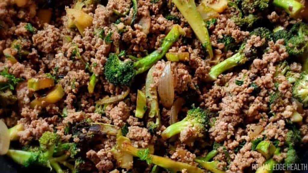 Ground beef cooked with broccoli, onions, and celery, shown in a close-up view of the mixed stir fry—perfect for those seeking easy ground beef dinners.