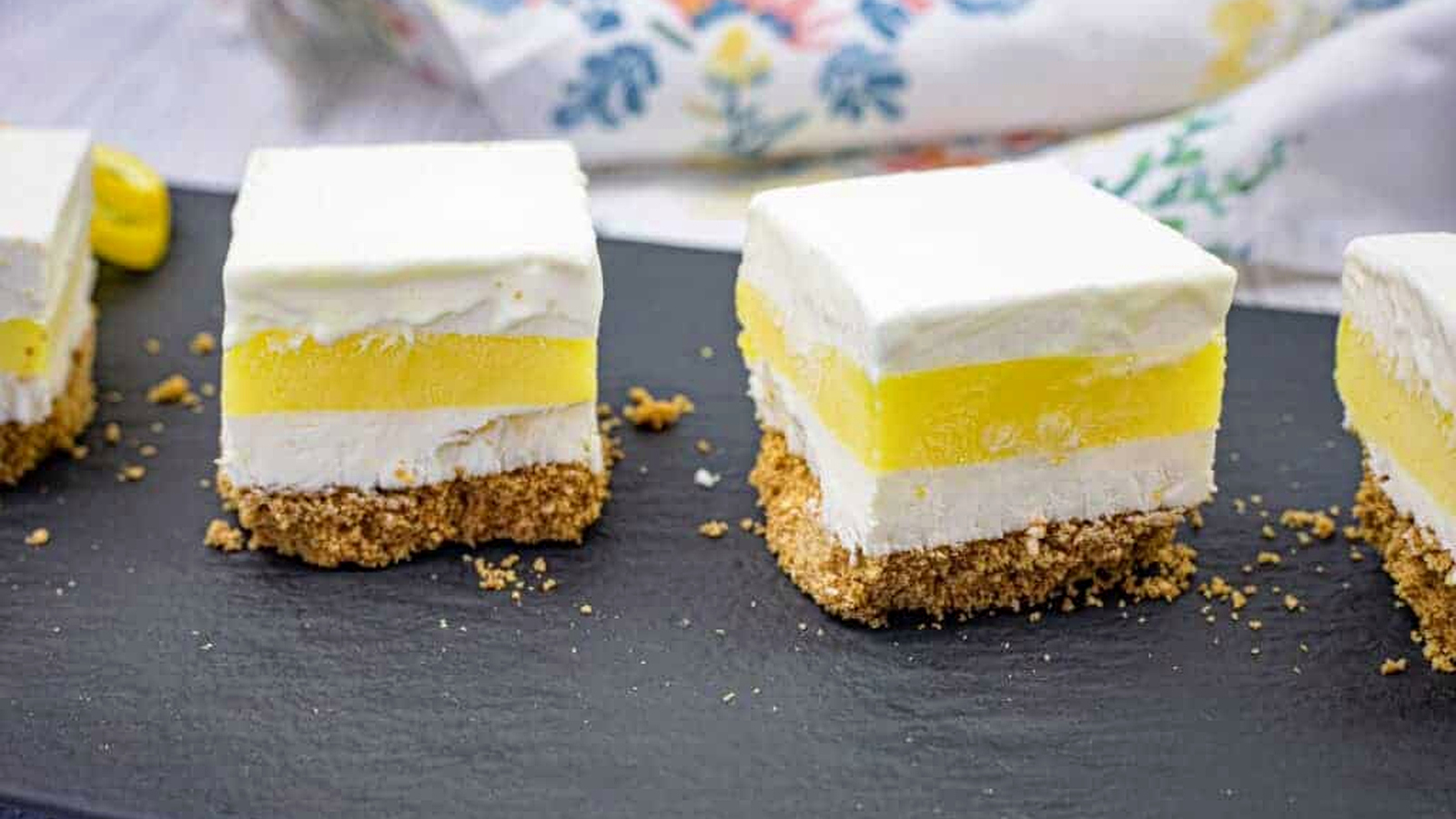 Close-up pieces of lemon lush on a slate plate.