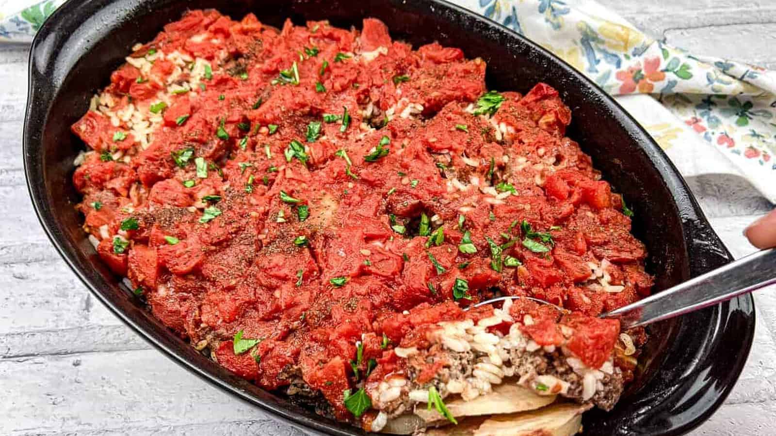 Shipwreck Casserole in a black dish with a spoon.