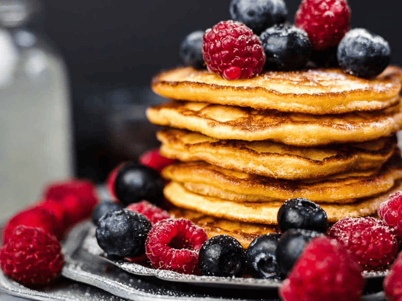 Keto Pancakes on top of each other with berries.