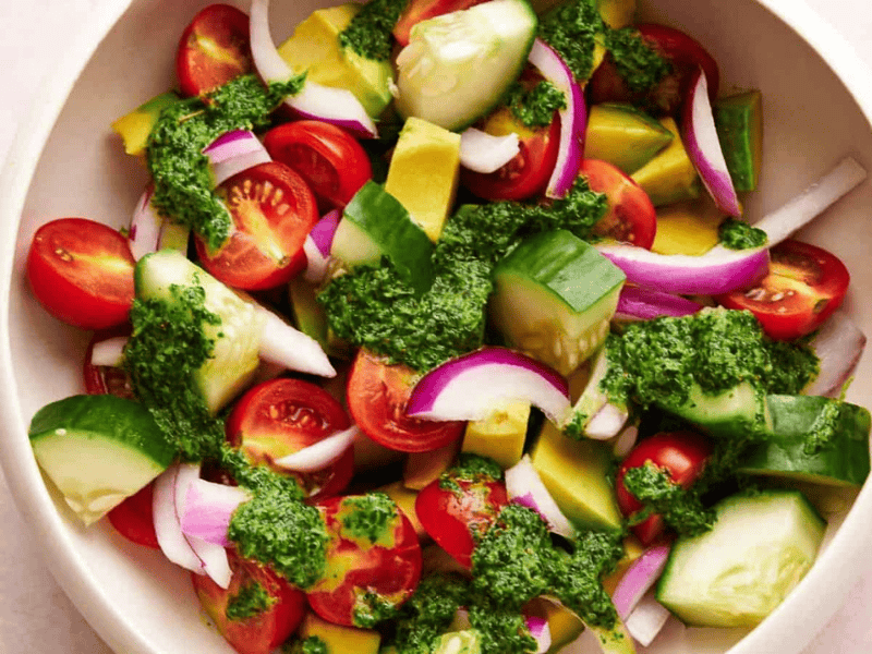 Avocado salad with dressing in a serving bowl.