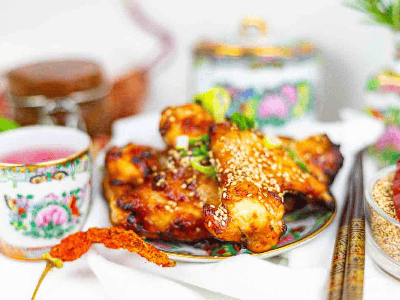 Baked chicken wings served with sesame garnish.