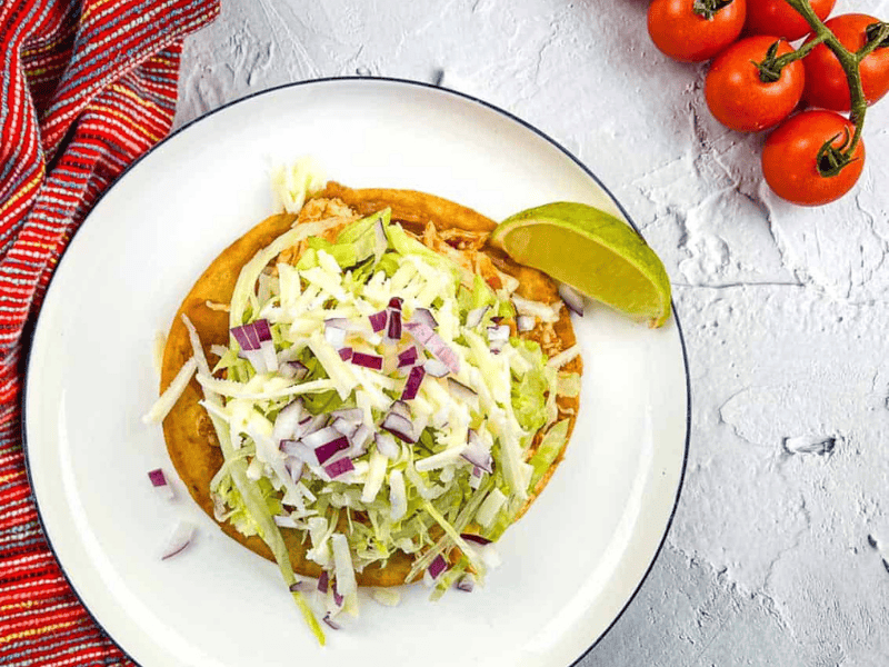Chicken Tinga Tostada on a plate.
