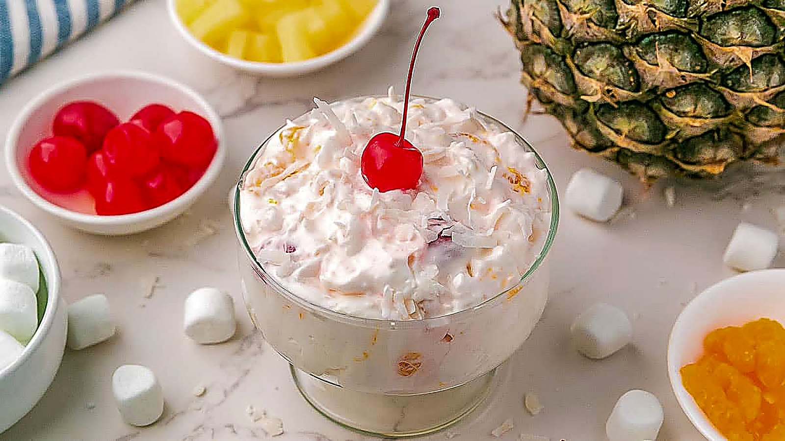 A colorful Ambrosia Salad beautifully arranged in a serving bowl.