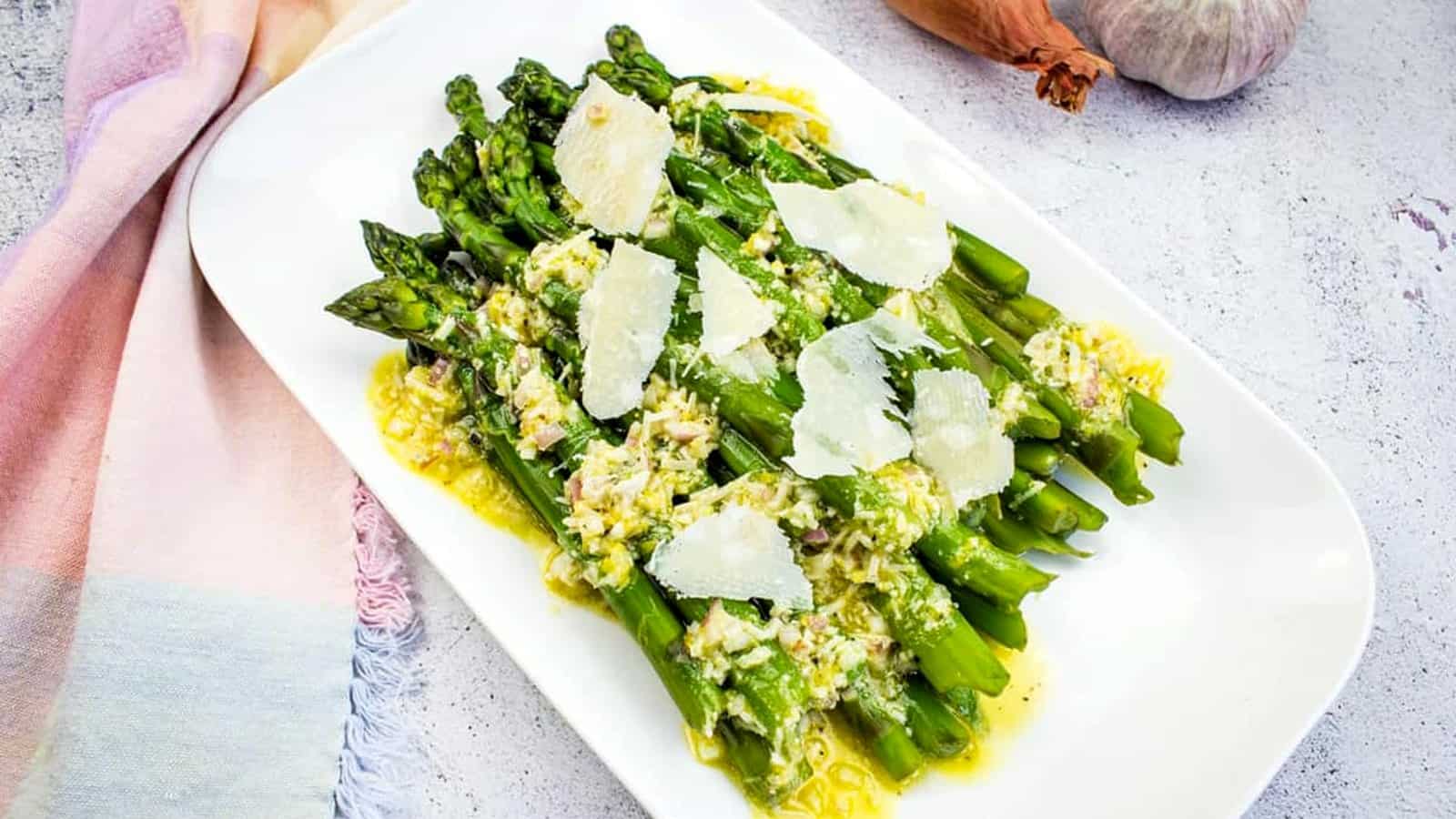 Asparagus with Lemon and Parmesan on a white platter.