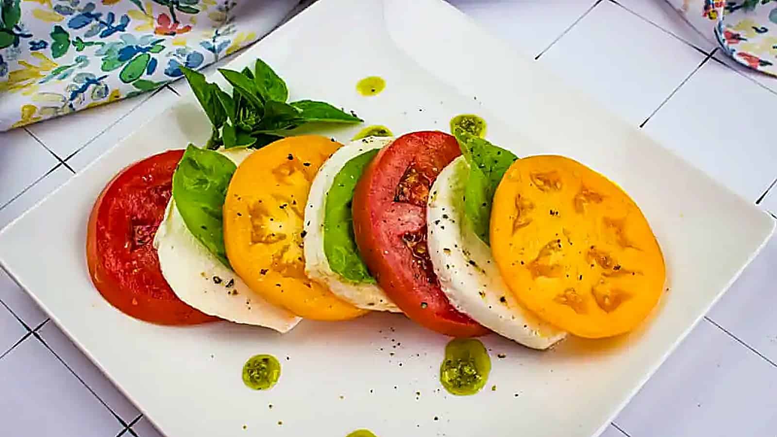 A top-down shot of a classic caprese salad in a black dish.
