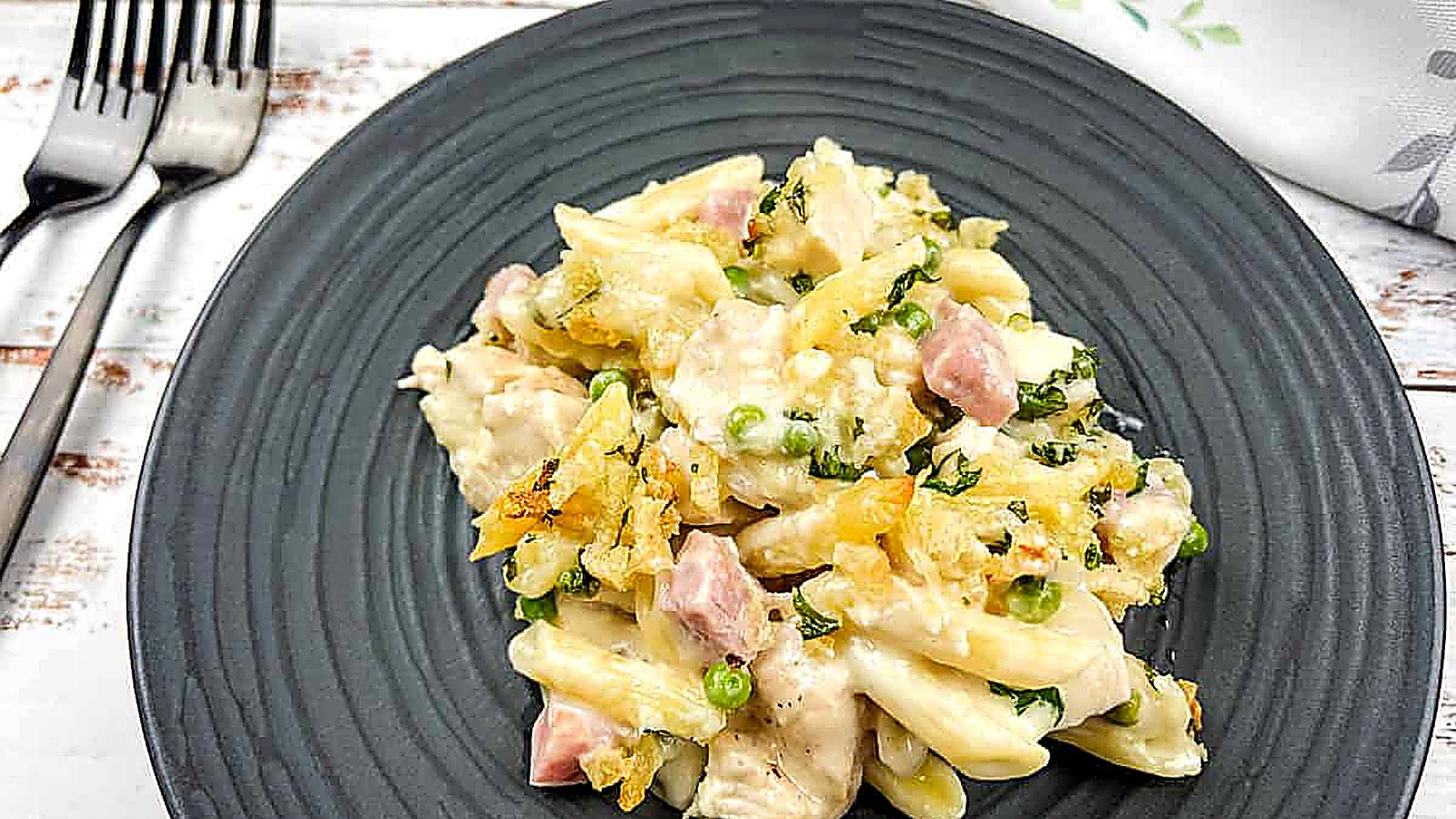 Chicken cordon bleu casserole on a black plate with a fork.
