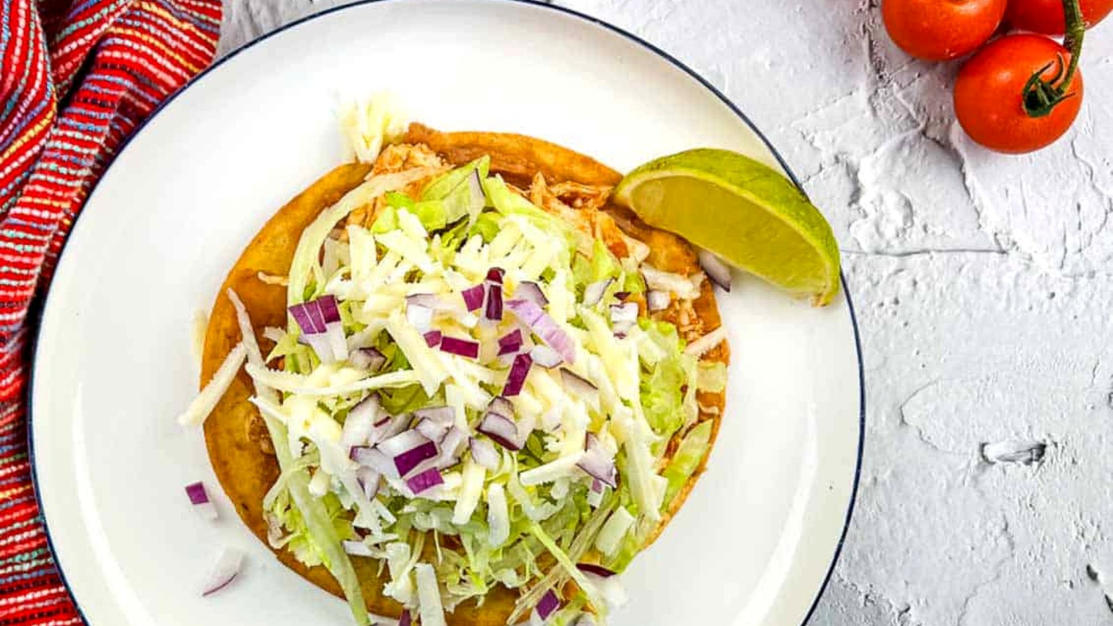 Chicken Tinga Tostada on a plate.
