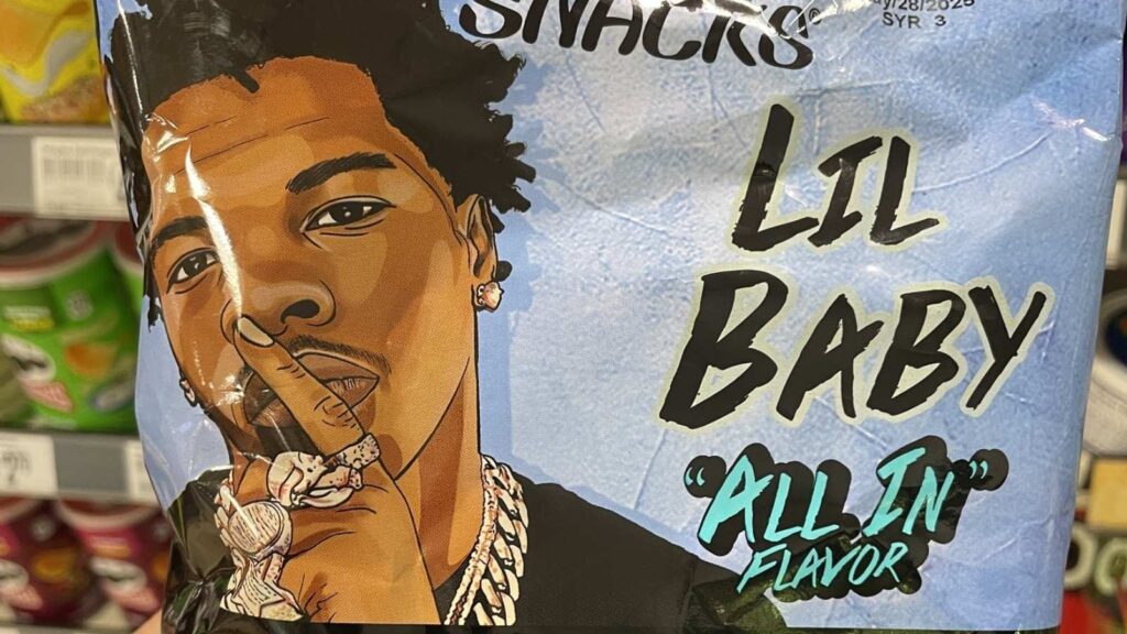 A snack bag features an illustrated man holding a finger to his lips, with text reading “Lil Baby ‘All In’ Flavor,” proudly representing one of the standout black-owned food brands.