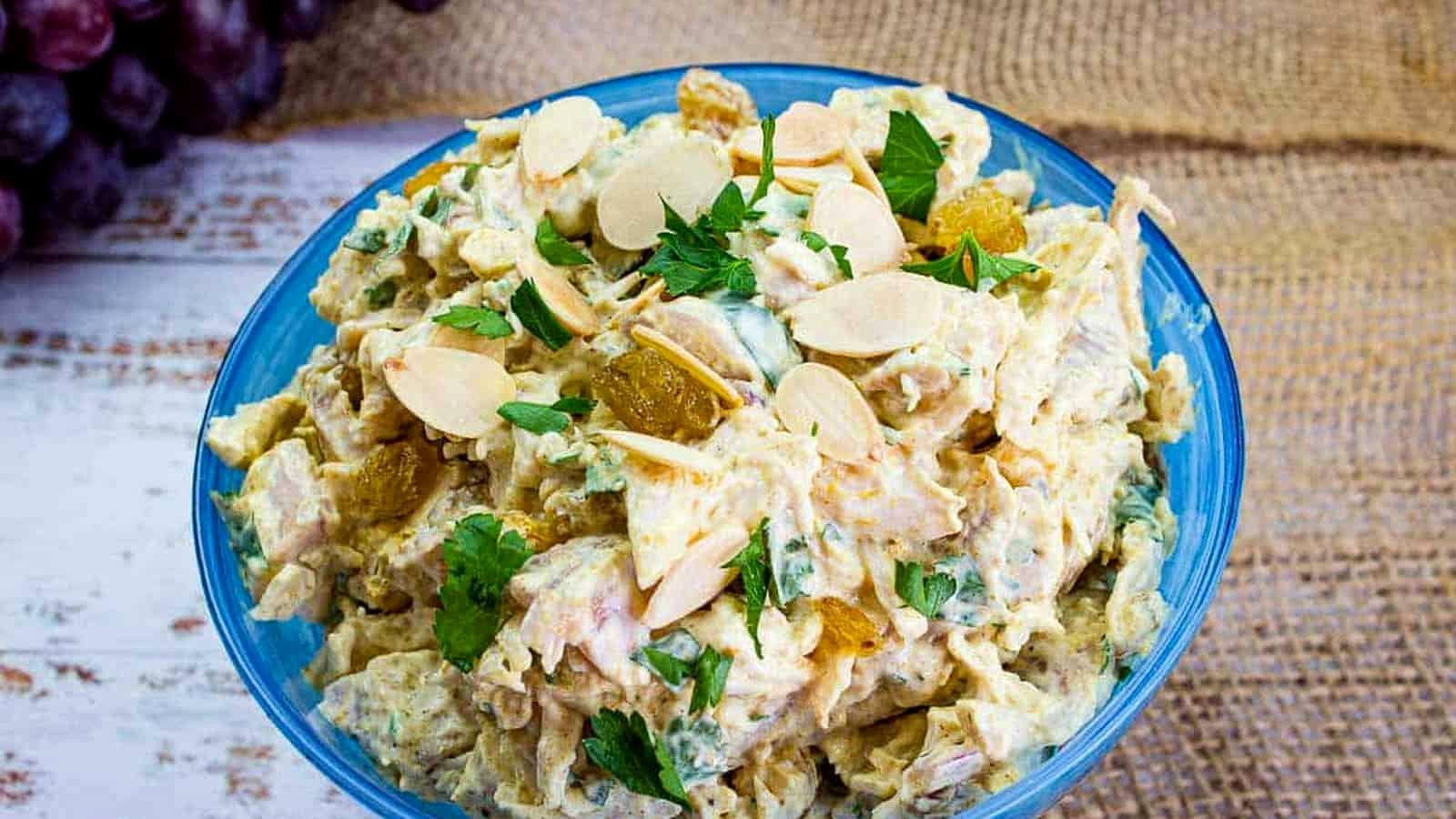 Curried chicken salad in a blue bowl.