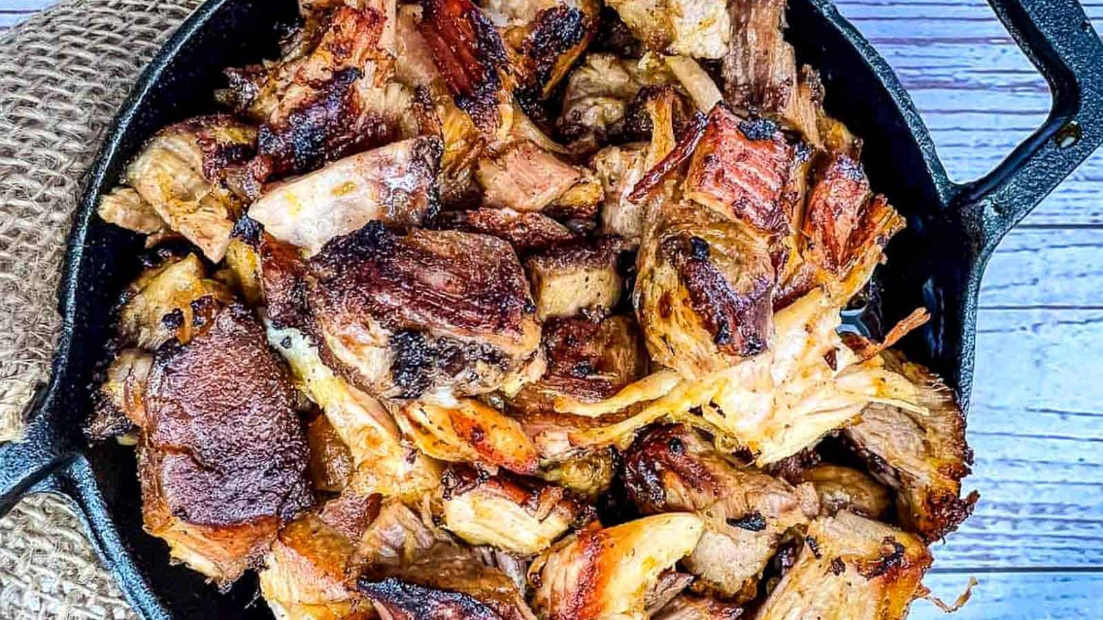 Carnitas in a round black dish.