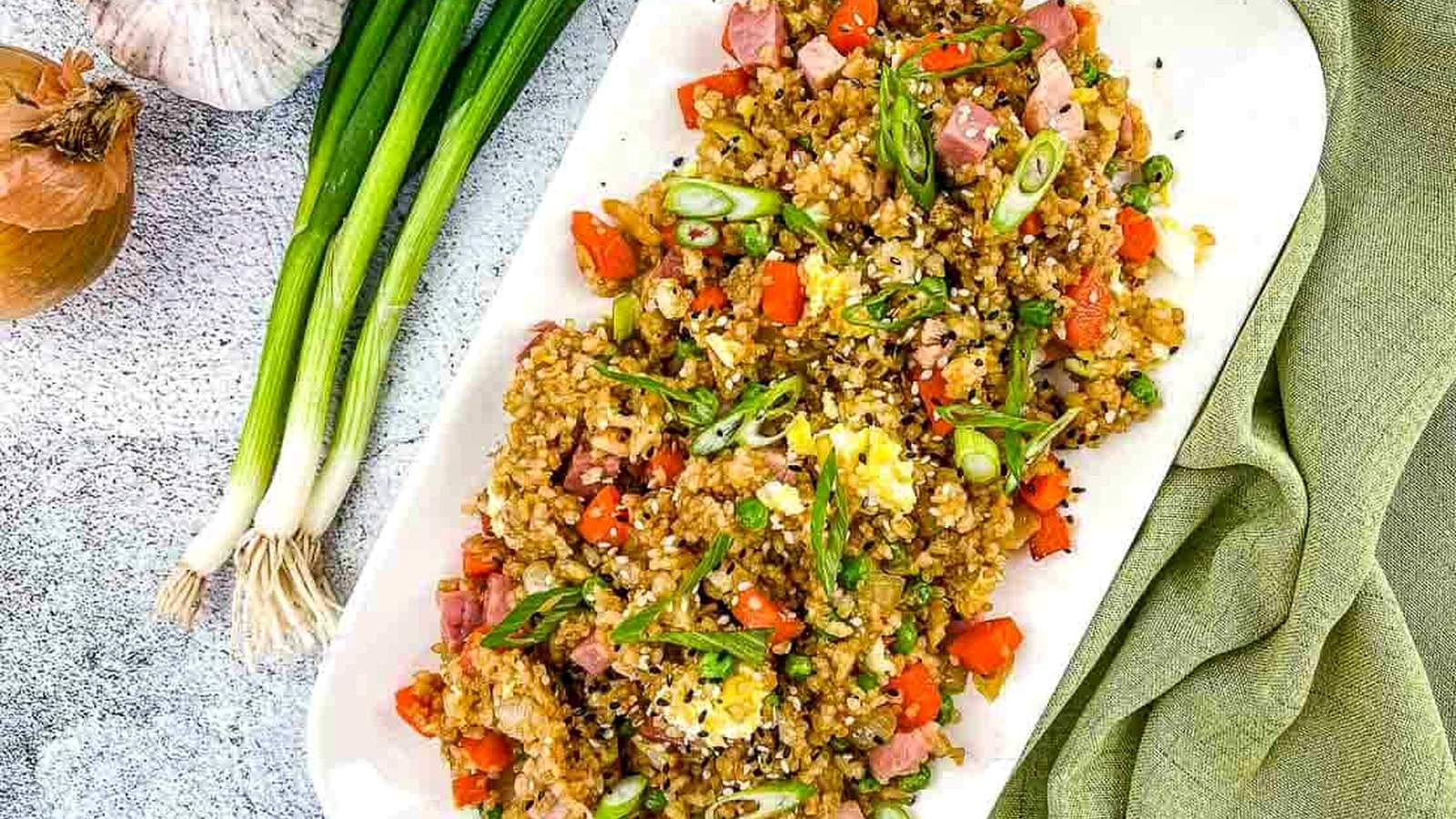 Ham fried rice on a white plate.