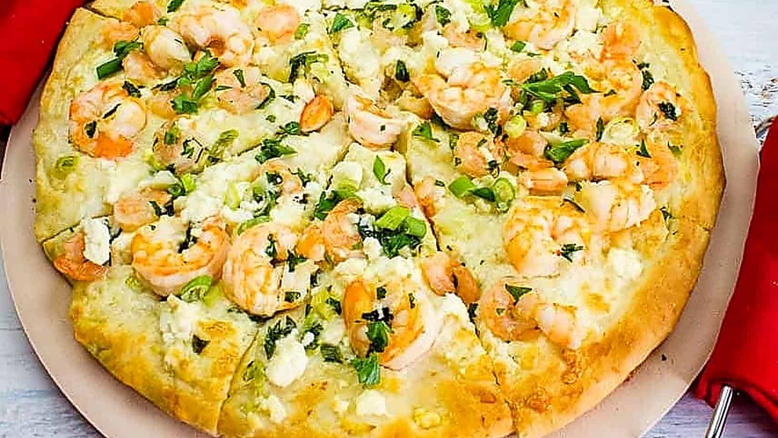 A pizza with shrimp and cheese on top.