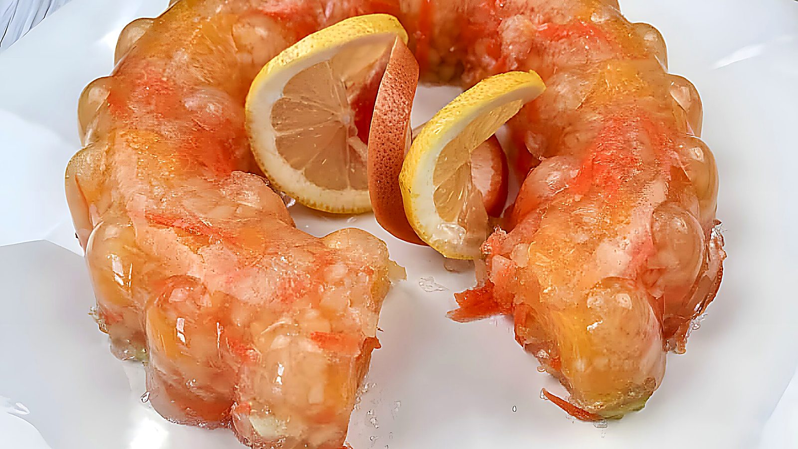 Sunshine salad with slices of oranges in the center served on a white plate.